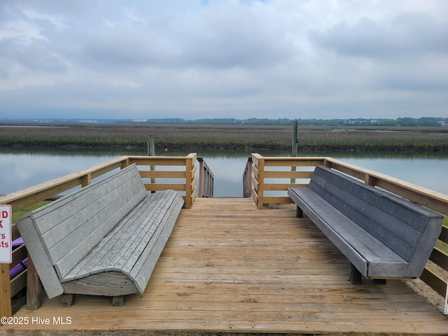view of dock with a rural view and a water view