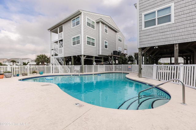 pool featuring central AC unit, a patio area, and fence