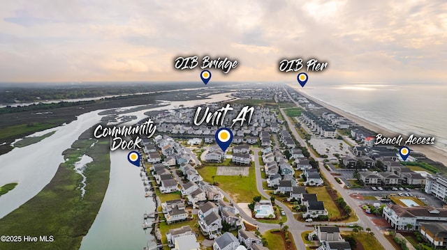 drone / aerial view featuring a water view and a residential view