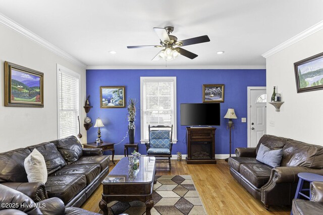 living area with recessed lighting, ornamental molding, ceiling fan with notable chandelier, and light wood finished floors