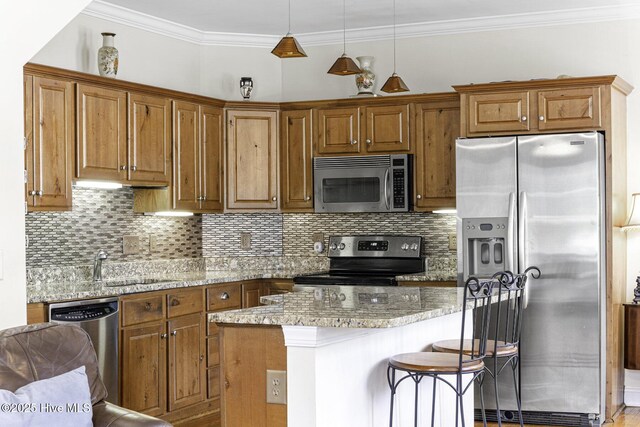kitchen featuring hardwood / wood-style floors, tasteful backsplash, appliances with stainless steel finishes, and brown cabinetry