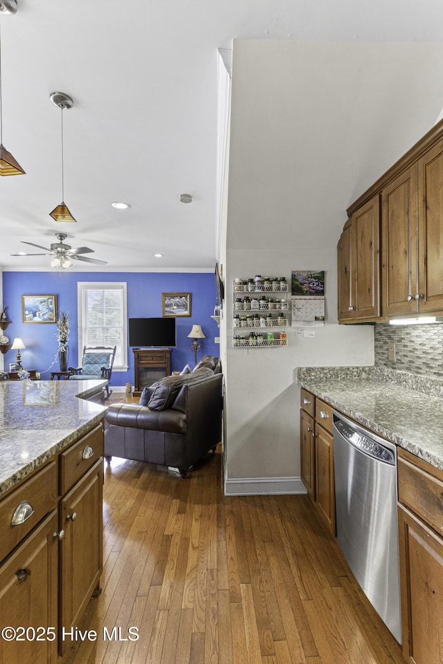 kitchen featuring decorative backsplash, ceiling fan, light stone counters, stainless steel dishwasher, and dark wood finished floors