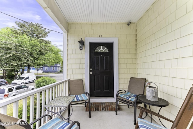 view of exterior entry featuring a porch