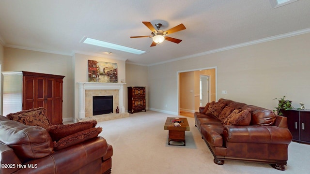 living area with ornamental molding, ceiling fan, and carpet flooring