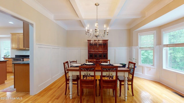dining room featuring beamed ceiling, coffered ceiling, light wood-style flooring, and a decorative wall