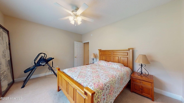 bedroom with ceiling fan, light colored carpet, and baseboards