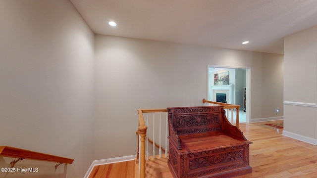 stairs featuring recessed lighting, wood finished floors, and baseboards