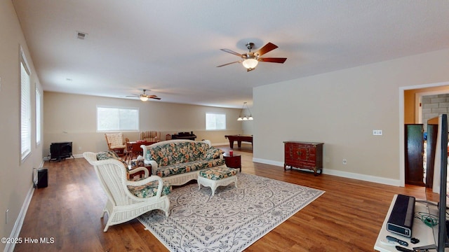 living room with ceiling fan, baseboards, wood finished floors, and visible vents