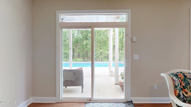 entryway with baseboards and wood finished floors