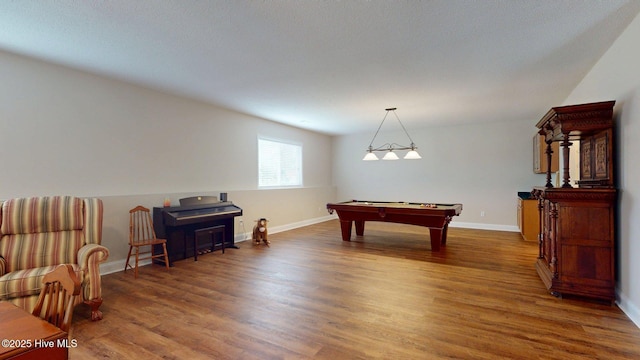 recreation room with baseboards, wood finished floors, and pool table