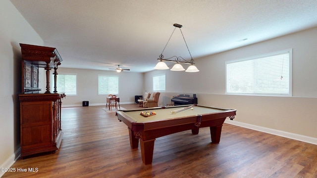 recreation room with baseboards, wood finished floors, and a healthy amount of sunlight