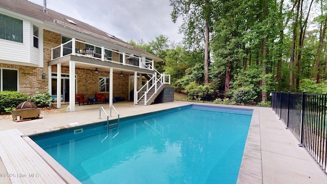 view of swimming pool with fence, a fenced in pool, a patio area, a ceiling fan, and stairs