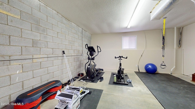 exercise room with a textured ceiling