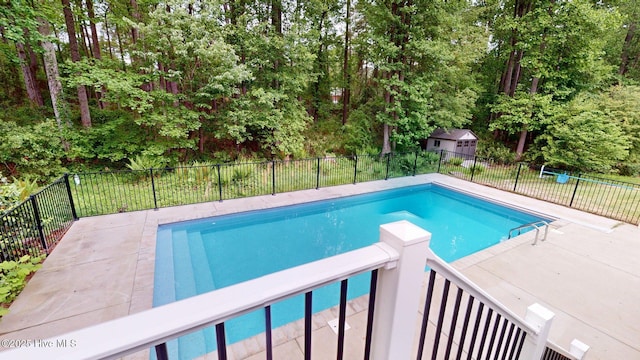 view of swimming pool with a fenced in pool and fence