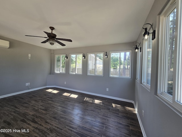 unfurnished room featuring baseboards, a ceiling fan, dark wood-style floors, and an AC wall unit