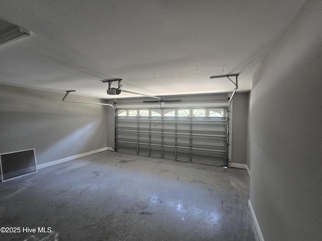 garage with a garage door opener and baseboards