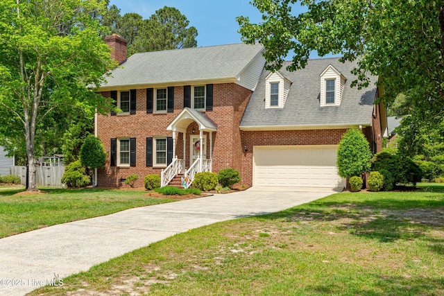2446 Pineridge Dr, Kinston, NC 28504 - colonial home with driveway, an attached garage, brick siding, and a chimney
