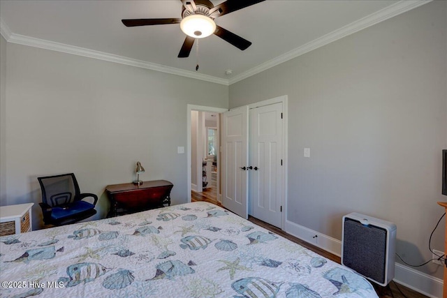 bedroom with baseboards, ornamental molding, and wood finished floors
