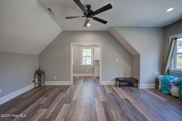 bonus room with ceiling fan, visible vents, vaulted ceiling, wood finished floors, and baseboards