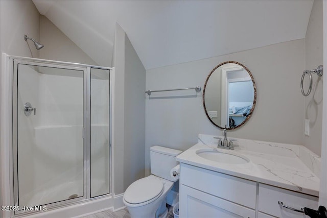full bathroom with vaulted ceiling, vanity, a stall shower, and toilet