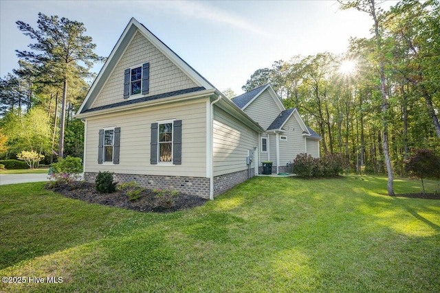 view of side of home with a yard