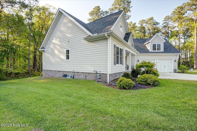 view of side of property with a shingled roof, concrete driveway, a yard, and a garage