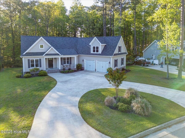view of front of property featuring an attached garage, a front yard, covered porch, and driveway