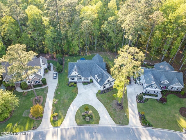 birds eye view of property with a view of trees