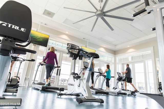 exercise room with french doors, a towering ceiling, visible vents, and plenty of natural light