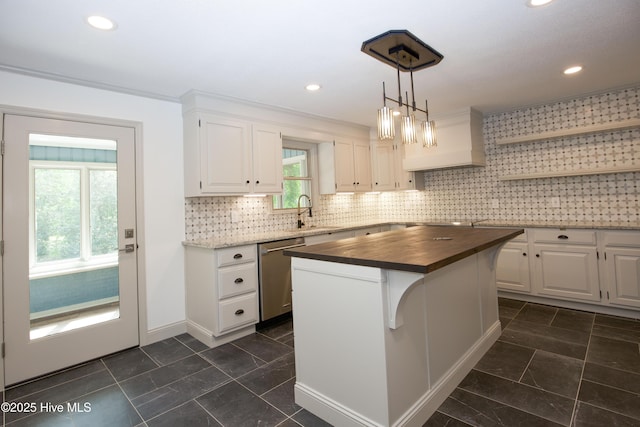 kitchen featuring open shelves, a sink, dishwasher, butcher block countertops, and white cabinetry