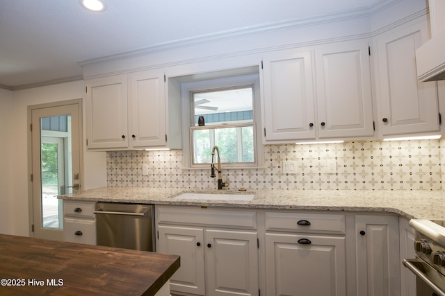 kitchen featuring a sink, appliances with stainless steel finishes, tasteful backsplash, and white cabinetry