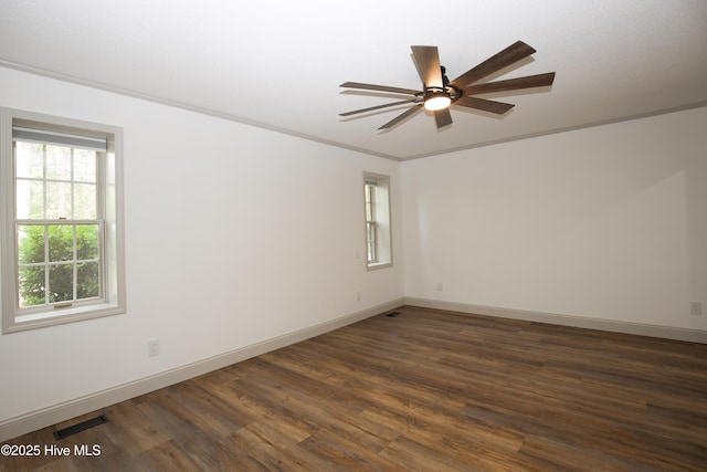 unfurnished room with visible vents, a ceiling fan, baseboards, and dark wood-style floors