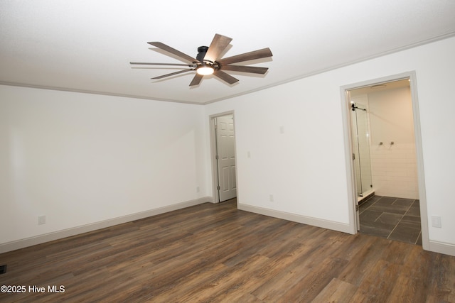 spare room featuring baseboards, a ceiling fan, and dark wood-type flooring