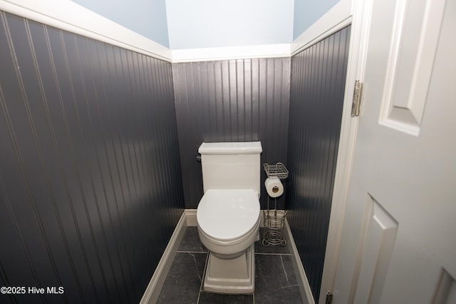 bathroom featuring wainscoting and toilet
