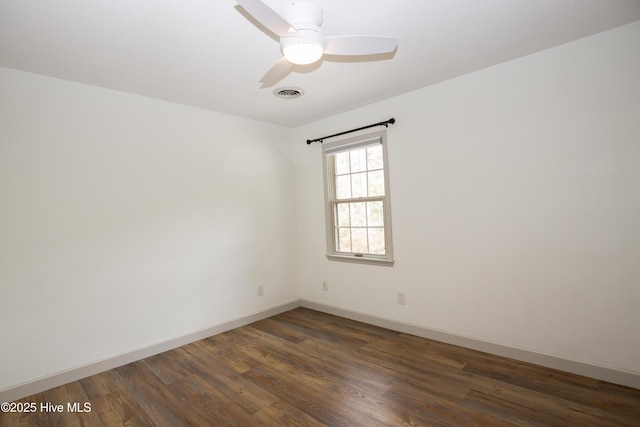 unfurnished room featuring baseboards, a ceiling fan, dark wood-style flooring, and visible vents