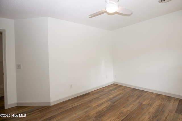 unfurnished room with a ceiling fan, baseboards, and wood finished floors