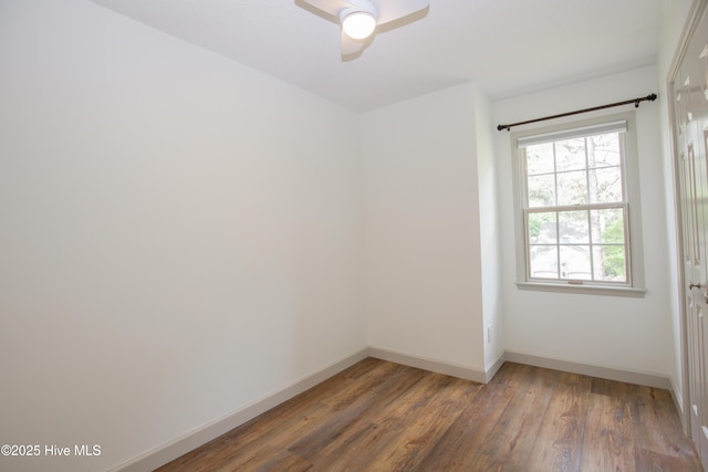 unfurnished room featuring baseboards, a ceiling fan, and wood finished floors