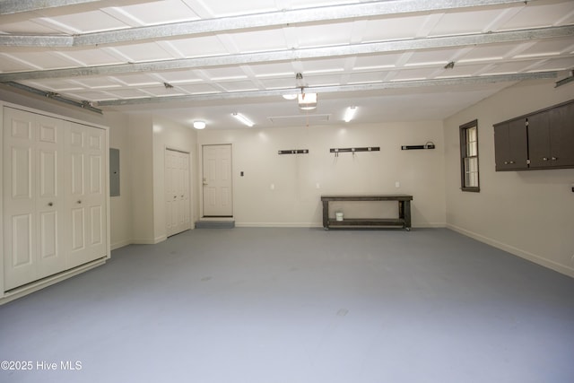 garage with baseboards, a garage door opener, and electric panel