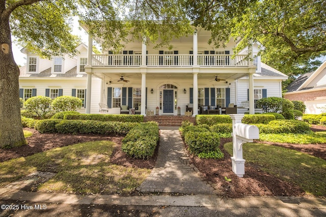 view of front of house featuring a porch, ceiling fan, and a balcony