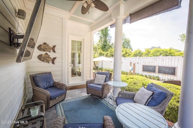 sunroom / solarium with coffered ceiling, ceiling fan, and beam ceiling