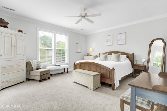 bedroom with visible vents, ornamental molding, a ceiling fan, and light colored carpet