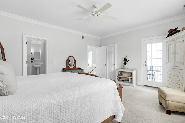 bedroom featuring carpet, ensuite bathroom, and crown molding