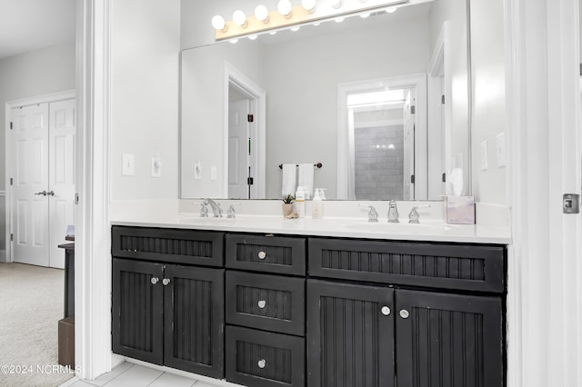 full bathroom featuring double vanity and a sink