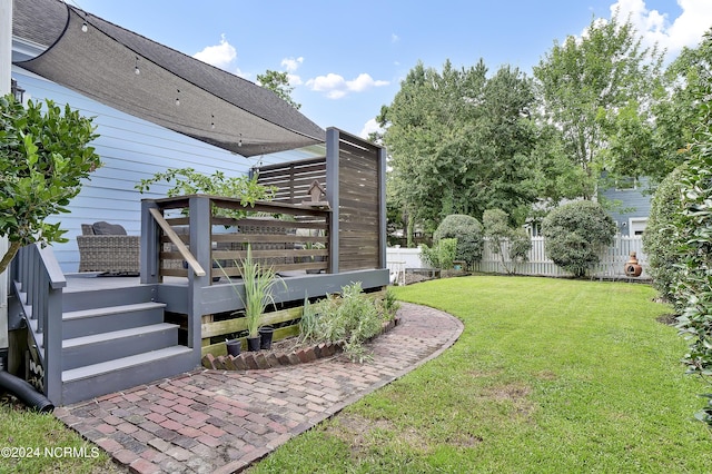 view of yard featuring a deck and fence