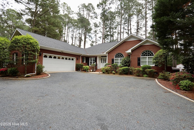 21 Birdie Dr, Whispering Pines, NC 28327 - single story home with an attached garage, driveway, and brick siding
