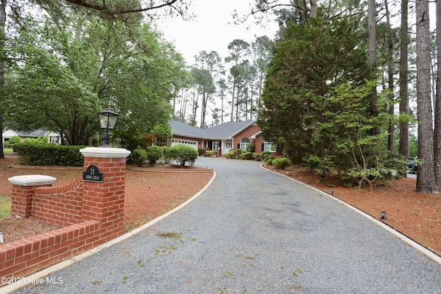 21 Birdie Dr, Whispering Pines, NC 28327 - view of front of home with gravel driveway