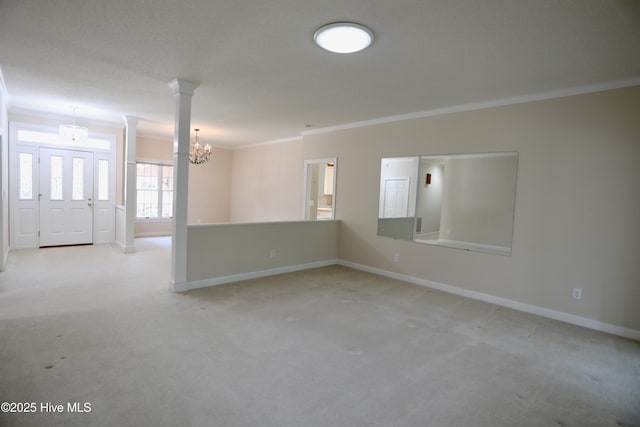 21 Birdie Dr, Whispering Pines, NC 28327 - spare room with baseboards, a chandelier, ornamental molding, carpet flooring, and ornate columns