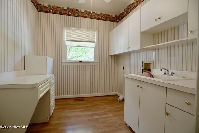 21 Birdie Dr, Whispering Pines, NC 28327 - clothes washing area with hookup for an electric dryer, a sink, light wood-style flooring, and hookup for a washing machine