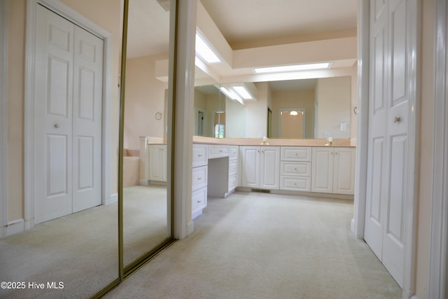 21 Birdie Dr, Whispering Pines, NC 28327 - bathroom with carpet floors, vanity, and a closet