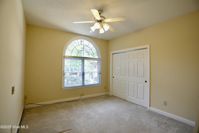 21 Birdie Dr, Whispering Pines, NC 28327 - unfurnished bedroom featuring carpet flooring, a textured ceiling, baseboards, and a closet
